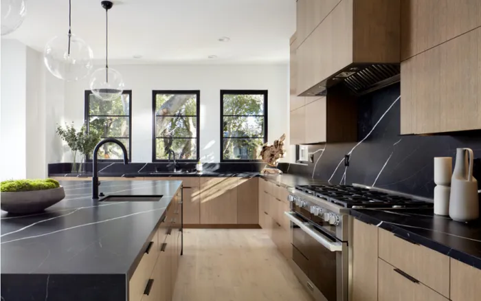 Modern custom kitchen with dark marble countertops